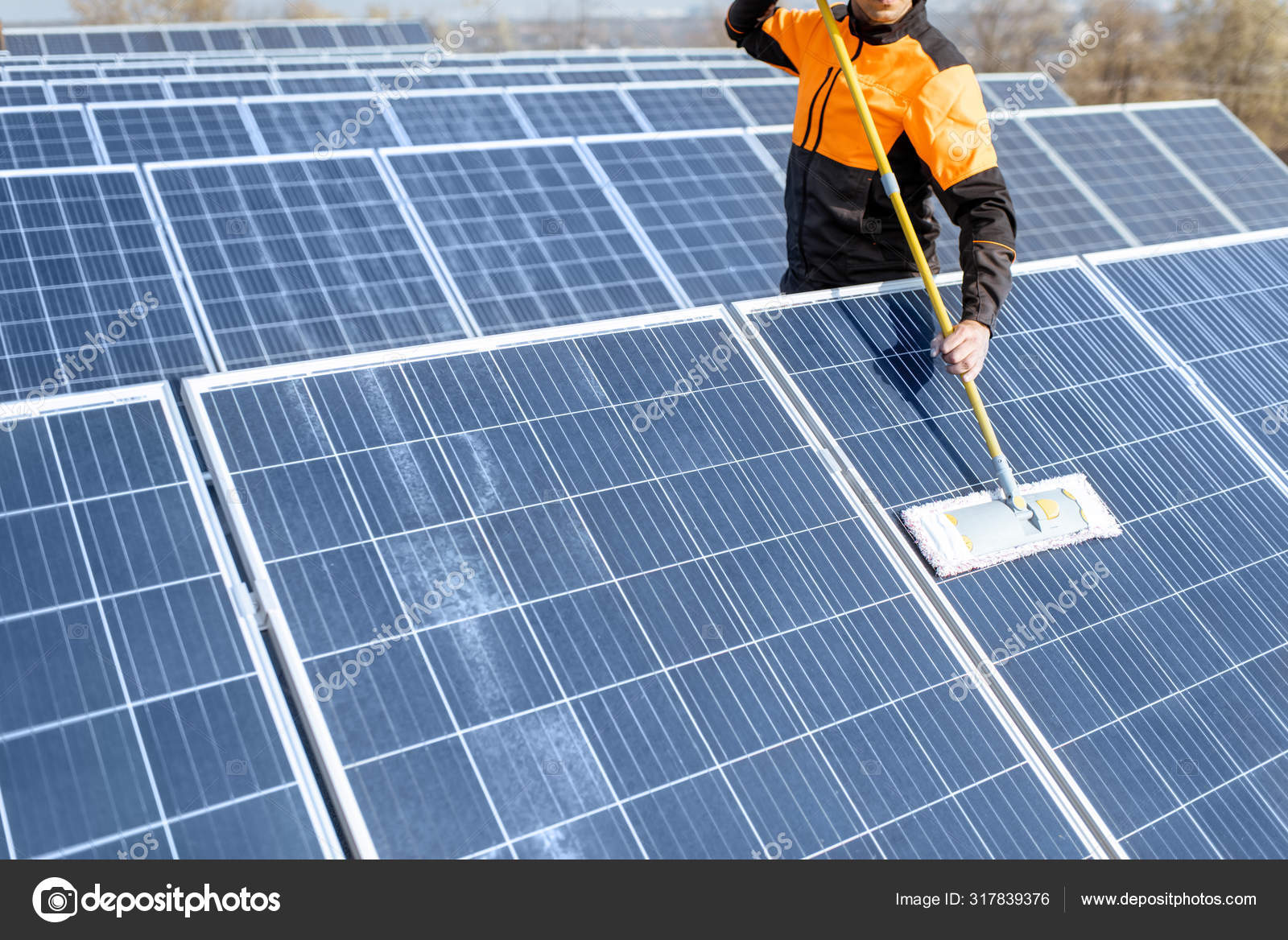 depositphotos_317839376-stock-photo-workman-cleaning-solar-panels